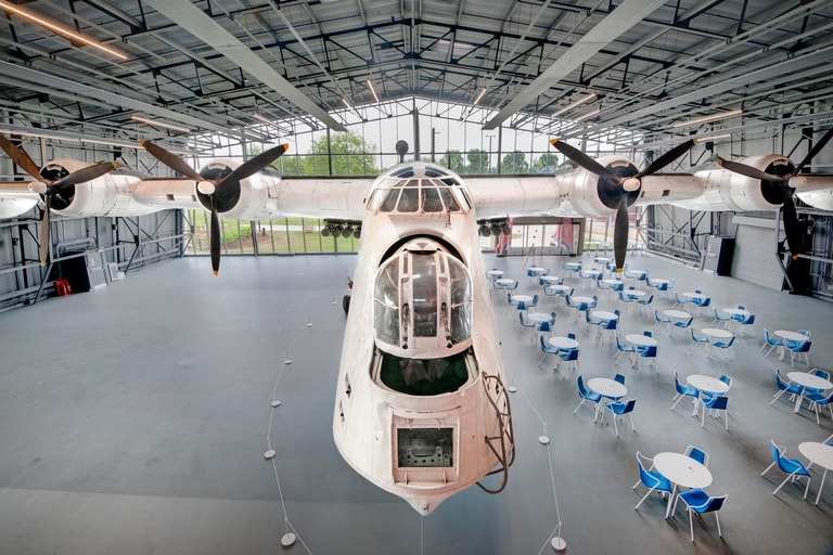 Large white metal aircraft with two wings and no wheels, © RAF Museum